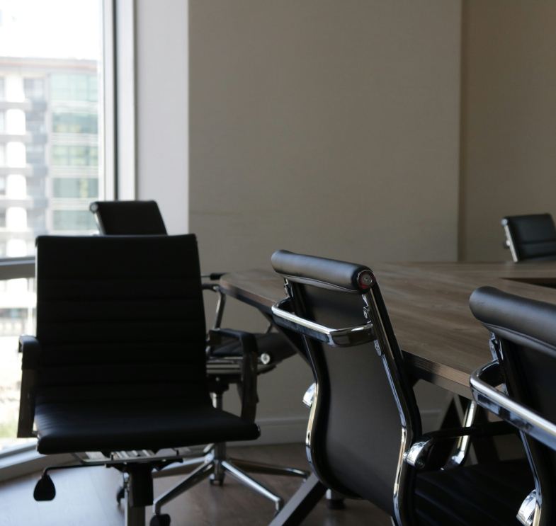 Boardroom with a long table and leather chairs