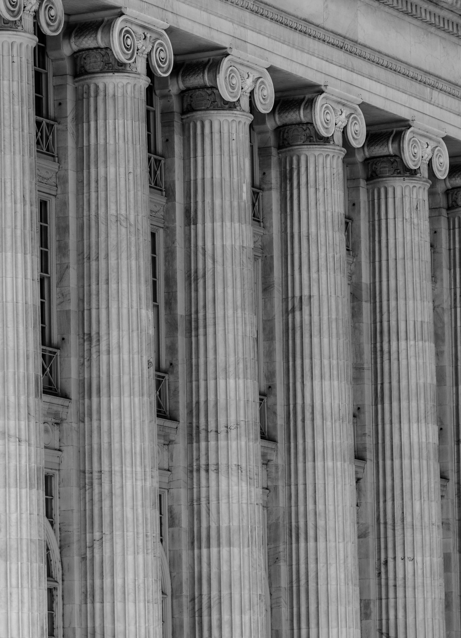 Classical stone columns of a courthouse in black and white