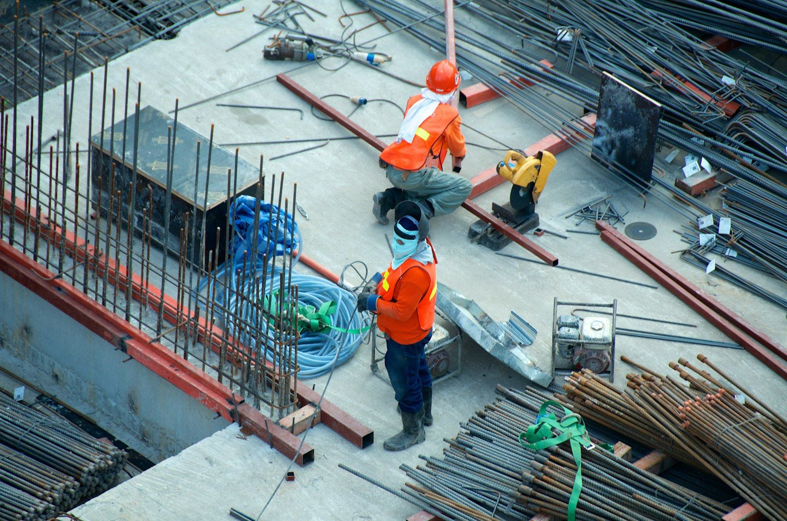 Workers on a construction site with steel reinforcement