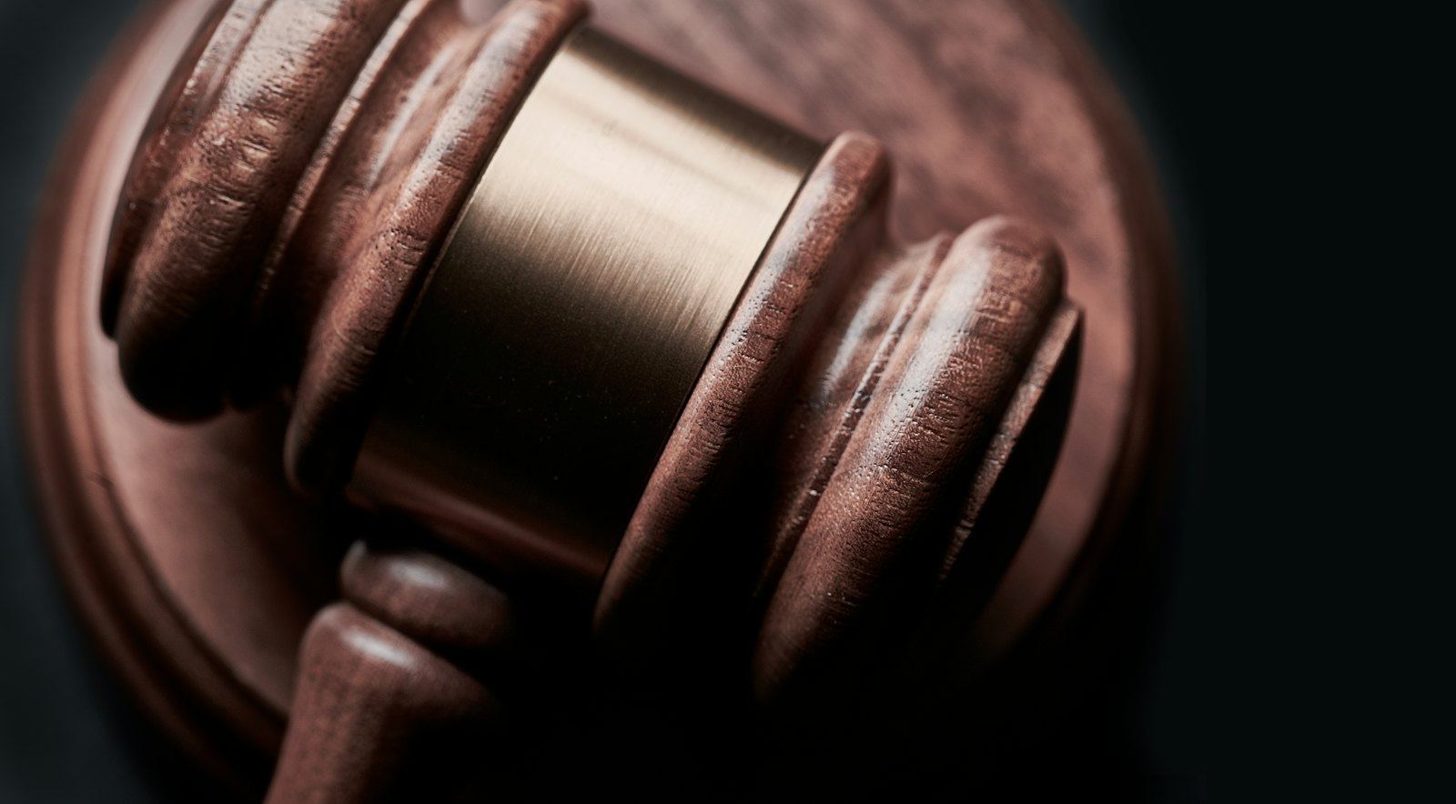 Close-up of a polished wooden gavel in low light