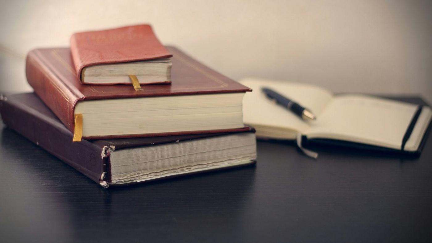 Leather-bound law books and an open notebook